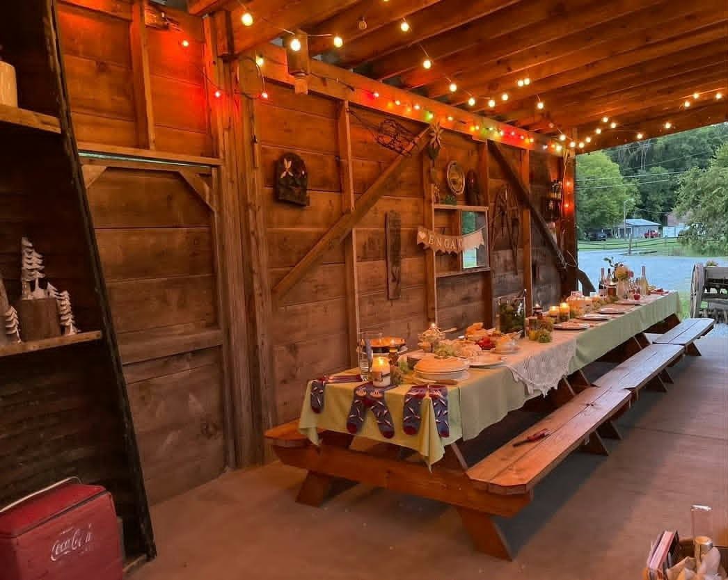Warm rustic gathering table under string lights