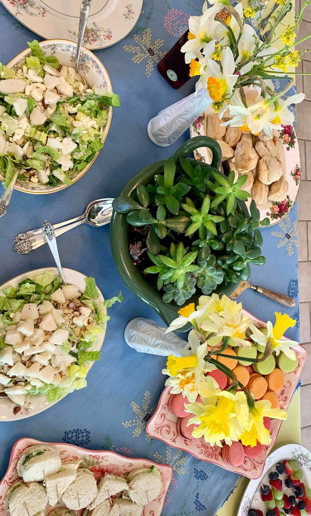 Tea luncheon table with salads, sandwiches, and macarons