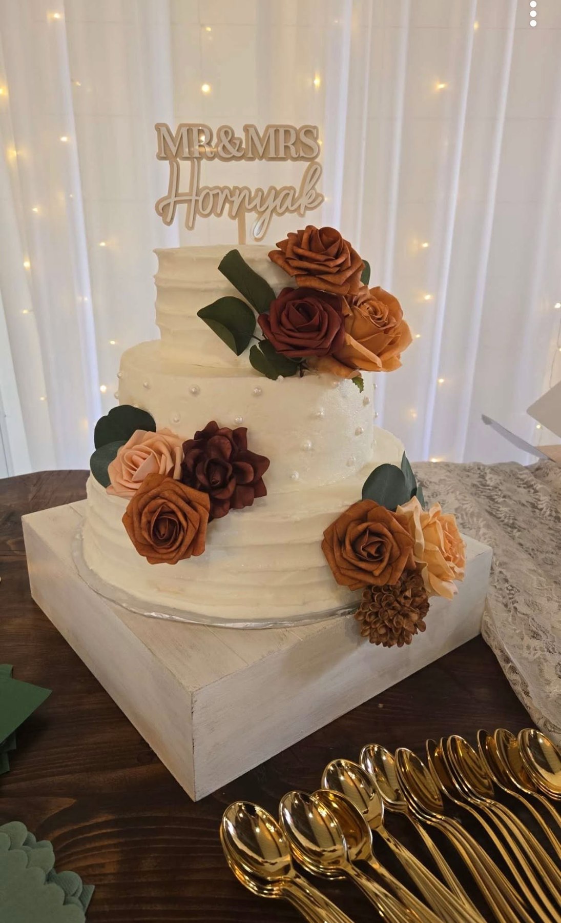 Three-tier wedding cake with floral accents